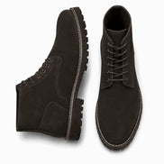 Dark brown suede combat boot, three-quarter angle showing heel and sole detailing