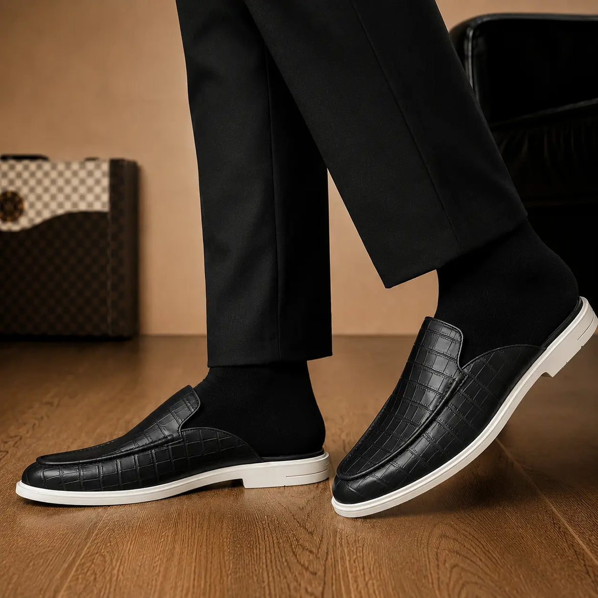 Melodiapelle Moreno Mule in black croc-embossed leather worn with trousers, on-feet shot