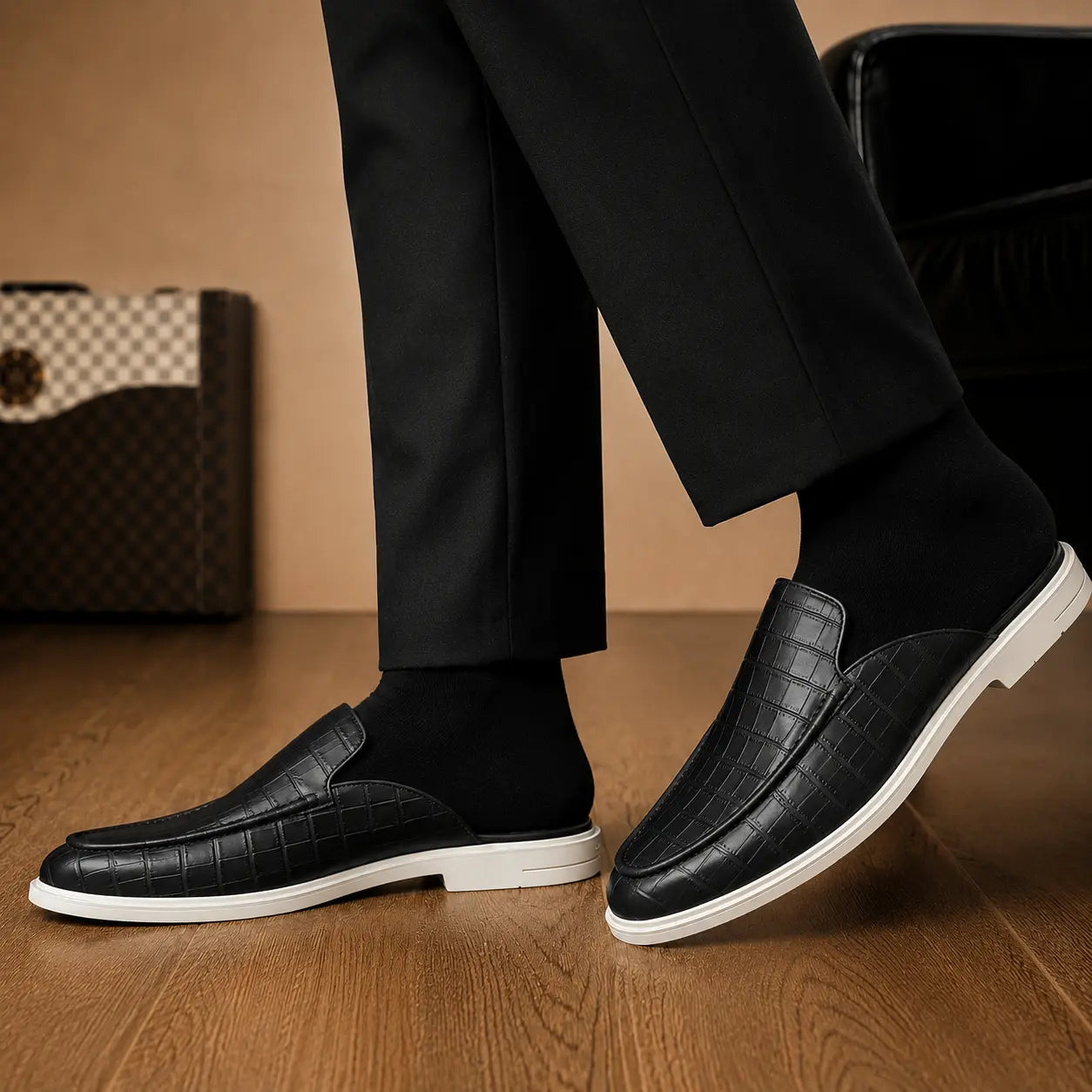 Melodiapelle Moreno Mule in black croc-embossed leather worn with trousers, on-feet shot