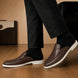 Melodiapelle Moreno Mule in dark brown croc-embossed leather worn with trousers, on-feet shot