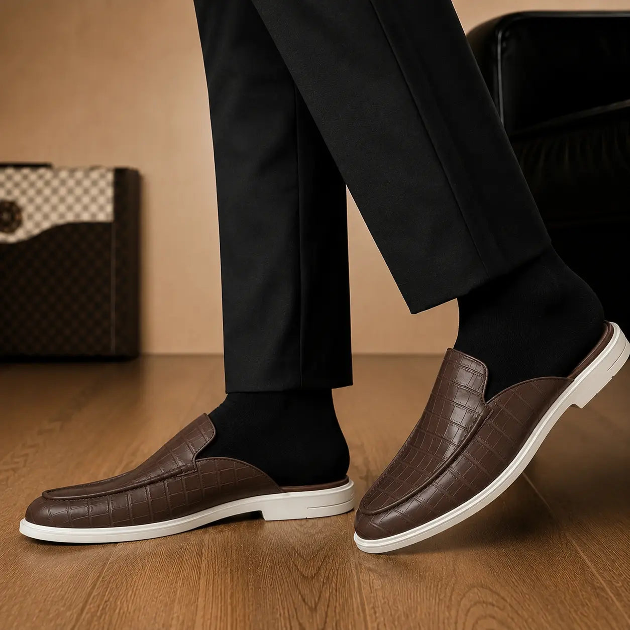 Melodiapelle Moreno Mule in dark brown croc-embossed leather worn with trousers, on-feet shot