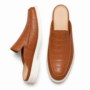 Tan croc-embossed leather mule, three-quarter angle showing heel and sole detailing