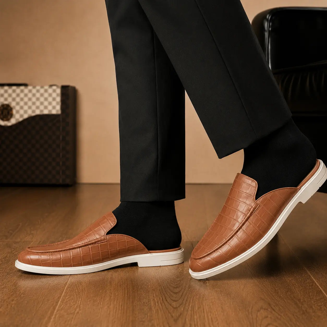Melodiapelle Moreno Mule in tan croc-embossed leather worn with trousers, on-feet shot