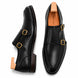 Black leather double monk strap shoe, three-quarter angle showing buckles and heel
