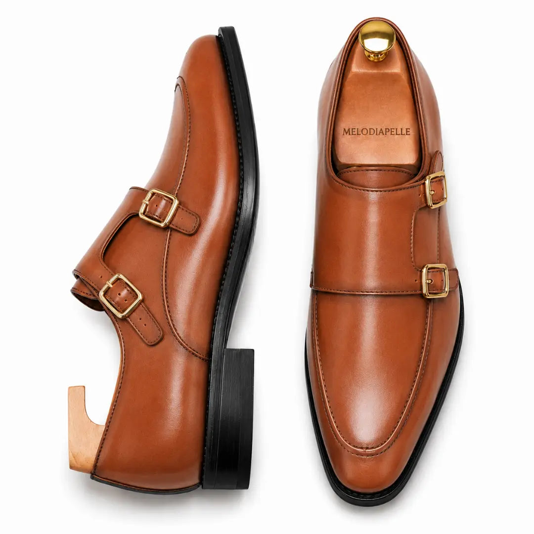 Tan leather double monk strap shoe, three-quarter angle showing buckles and heel