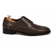 Side profile of the Mortlach Studded Apron Derby in brown leather on white background