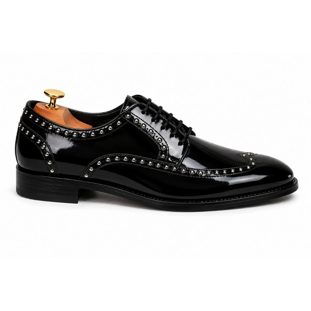 Side profile of the Mortlach Studded Apron Derby in nero black leather on white background