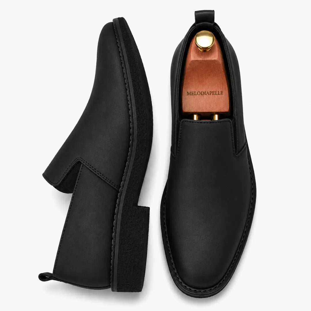 Black leather opera slip-on, three-quarter angle showing heel and gusset detailing