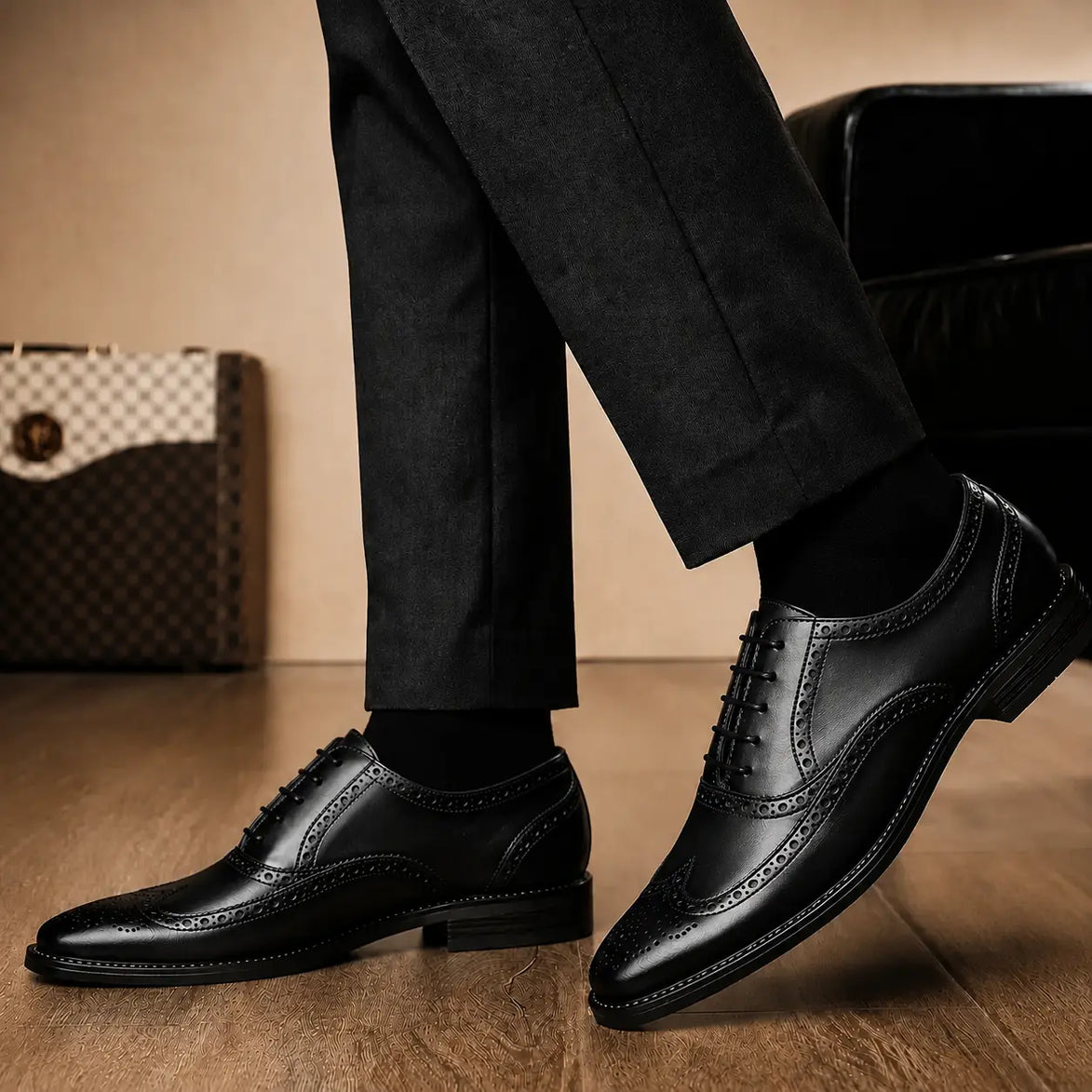 Melodiapelle Mossverde Wingtip Brogue Oxford in black leather worn with formal trousers, on-feet shot