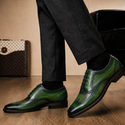 Melodiapelle Mossverde Wingtip Brogue Oxford in sage green leather worn with formal trousers, on-feet shot