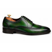 Side profile of the Mossverde Wingtip Brogue Oxford in sage green leather on white background
