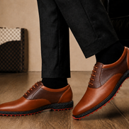 Melodiapelle Motif Golf Shoe in tan and dark brown leather worn with trousers, on-feet lifestyle shot