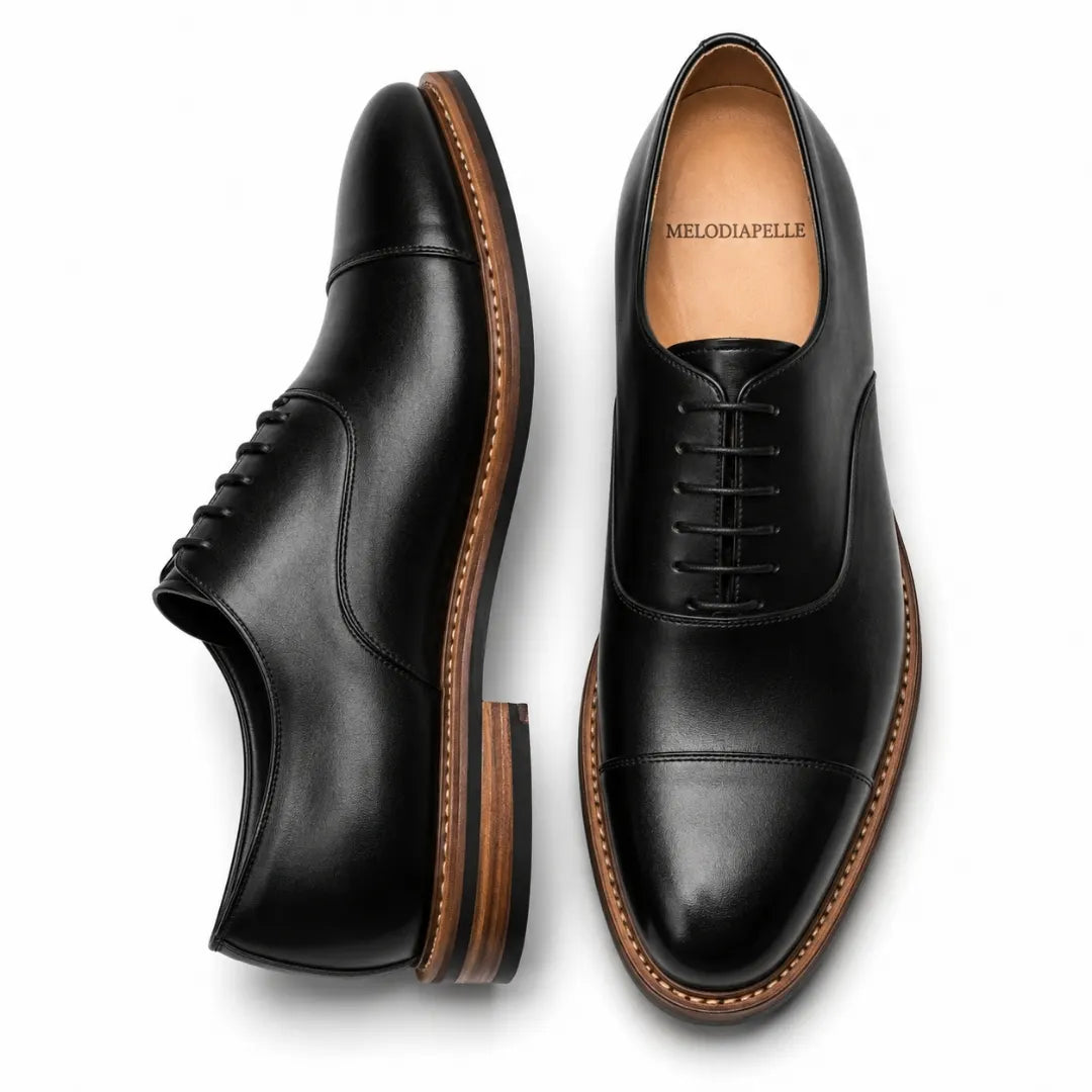 Black leather cap-toe Oxford, three-quarter angle showing heel and toe detailing