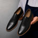 Man holding a pair of Melodiapelle Mount Pleasant Oxford shoes in black leather, close-up