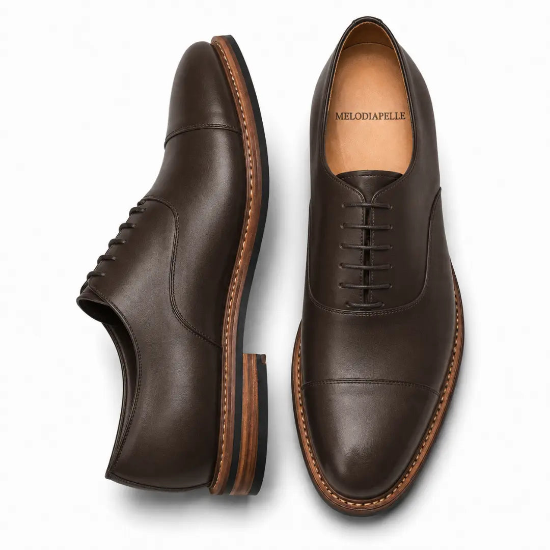 Dark brown leather cap-toe Oxford, three-quarter angle showing heel and toe detailing