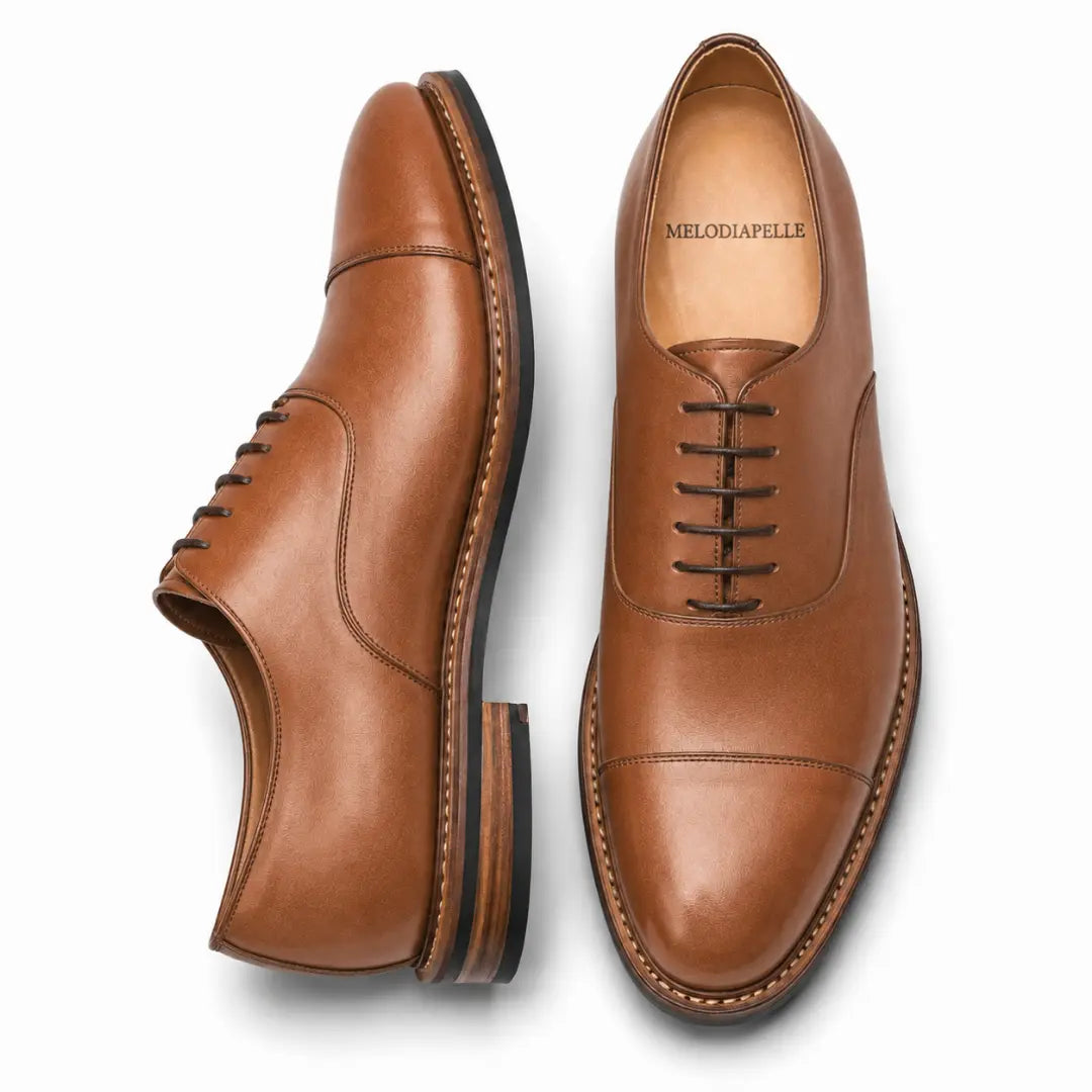 Tan leather cap-toe Oxford, three-quarter angle showing heel and toe detailing