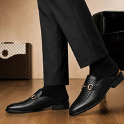 Melodiapelle Munar Mule in black woven leather worn with trousers, on-feet shot