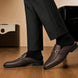 Melodiapelle Munar Mule in dark brown woven leather worn with trousers, on-feet shot