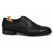 Side profile of the Munich Woven Brogue Oxford in black leather on white background