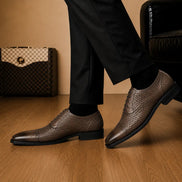 Melodiapelle Munich Woven Brogue Oxford in brown leather worn with formal trousers, on-feet shot