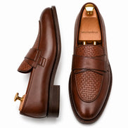 Dark chocolate leather croc-embossed penny loafer, three-quarter angle showing heel and saddle detailing