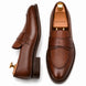Dark chocolate leather croc-embossed penny loafer, three-quarter angle showing heel and saddle detailing