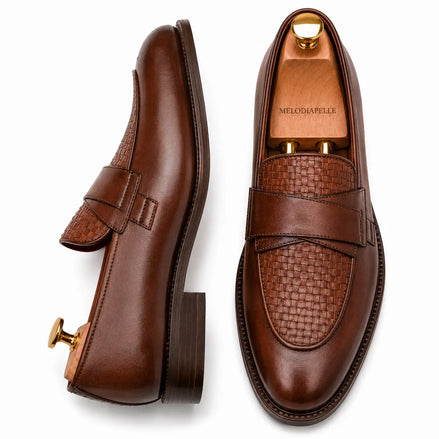 Dark chocolate leather croc-embossed penny loafer, three-quarter angle showing heel and saddle detailing