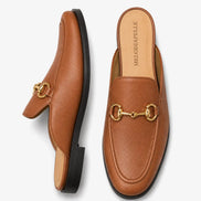 Tan leather horsebit mule, three-quarter angle showing sole detailing