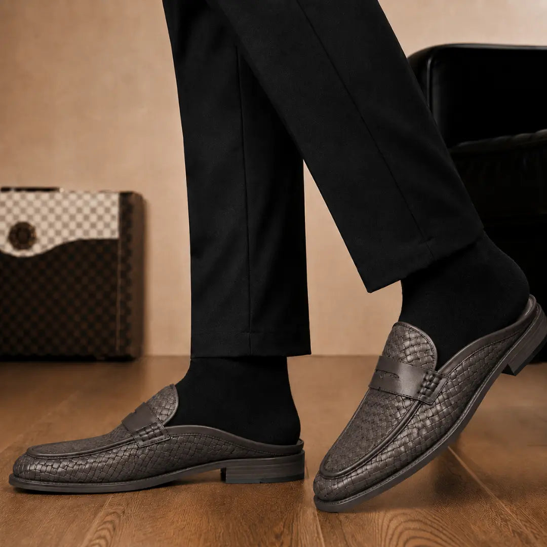 Melodiapelle Rossi Mule in dark brown woven leather worn with trousers, on-feet shot