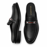Black leather bit-buckle mule loafer, three-quarter angle showing heel and buckle detailing