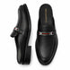 Black leather bit-buckle mule loafer, three-quarter angle showing heel and buckle detailing