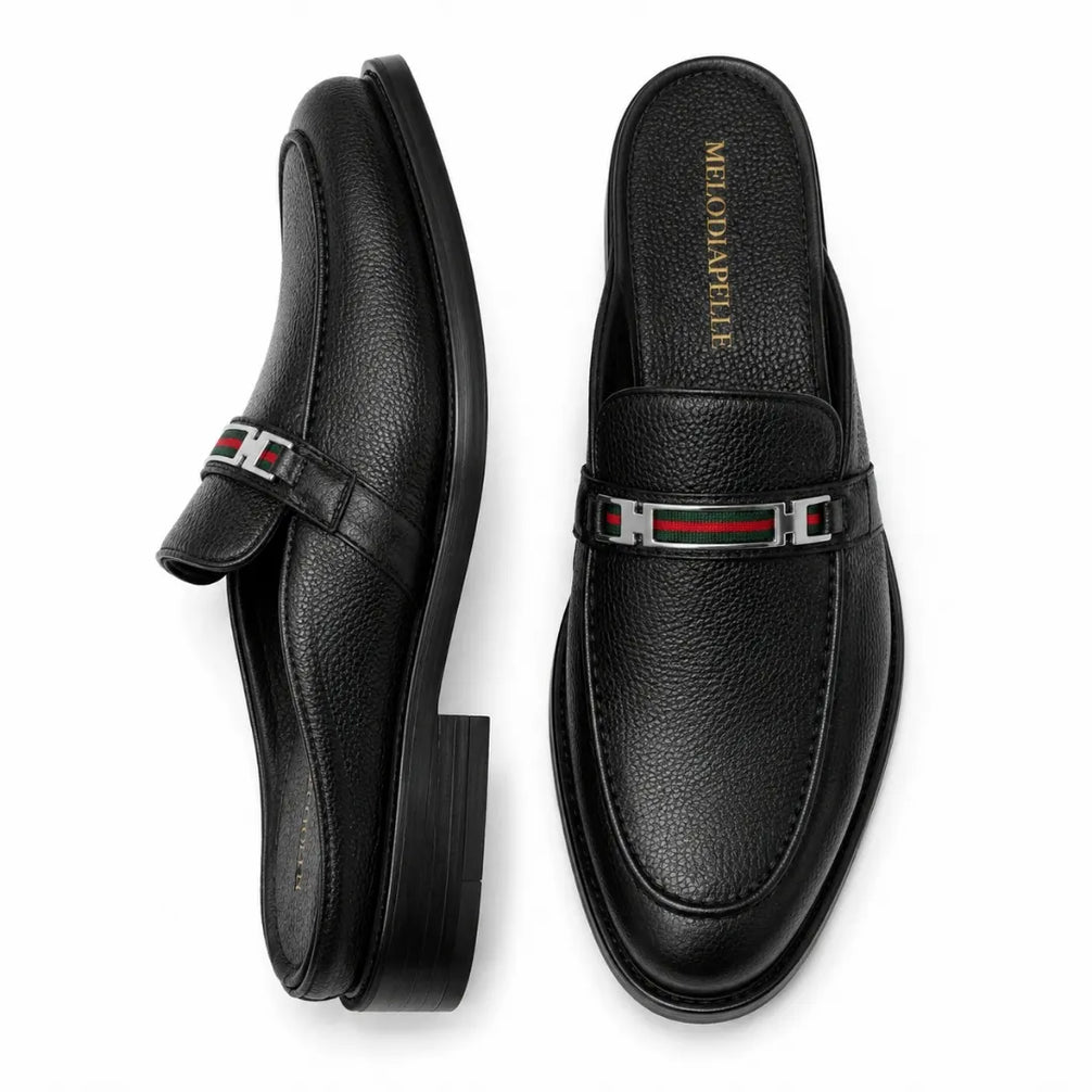 Black leather bit-buckle mule loafer, three-quarter angle showing heel and buckle detailing