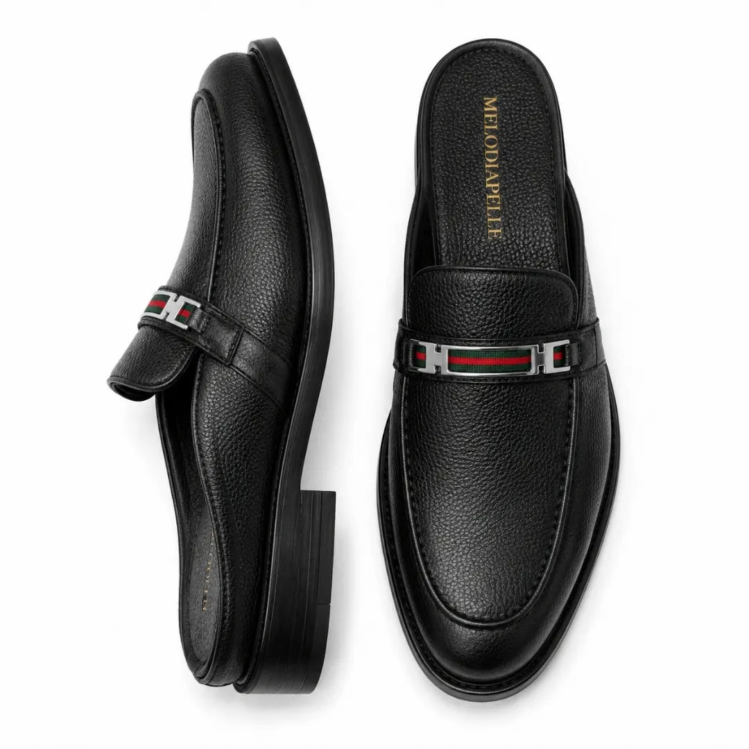 Black leather bit-buckle mule loafer, three-quarter angle showing heel and buckle detailing